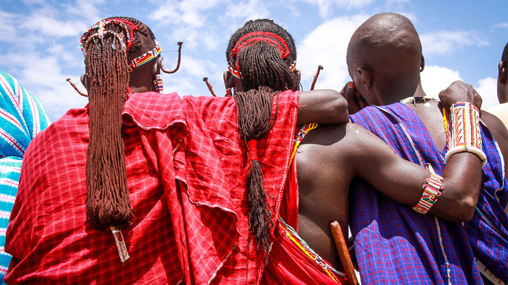 Kenyan Men with arms wrapped around each other