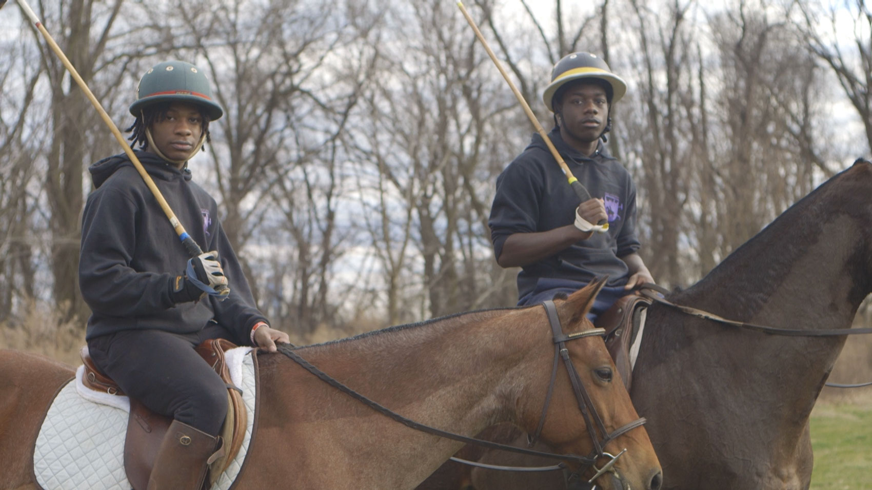 Polo_Prodigy_Stilll_ Two Kids on Horses holding polo gear